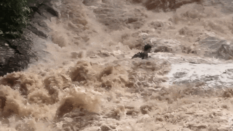 Tourists are shown being swept downstream in Mae Sa Waterfall flash flood in Thailand
